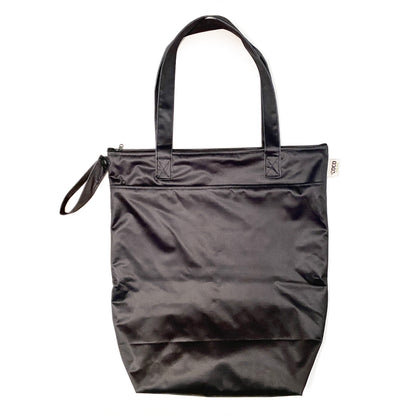 A black zipped tote bag, made from bamboo fibres, featuring two zipped sections and a handy loop tab to easily roll up the bag for storage. Image shows the bag upright with handles showing.