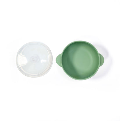 A forest green silicone children’s feeding bowl, with lid and suction cup. Image shows the bowl with lid separately.