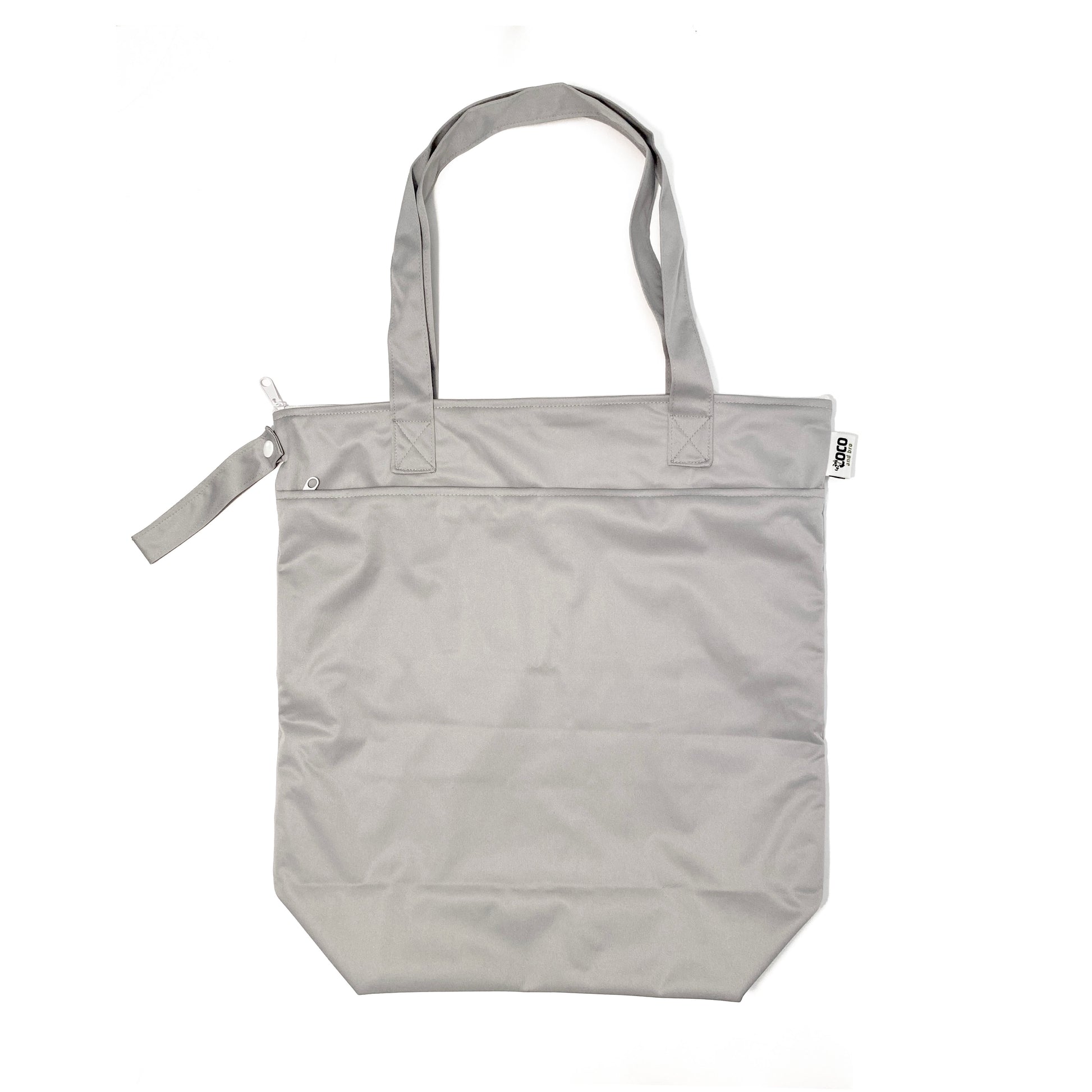 A zipped tote bag, made from bamboo fibres in grey, featuring two zipped sections and a handy loop tab to easily roll up the bag for storage. Image shows the bag upright with handles showing.