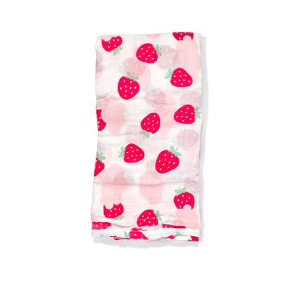 A folded muslin swaddle blanket with a pink strawberries design.