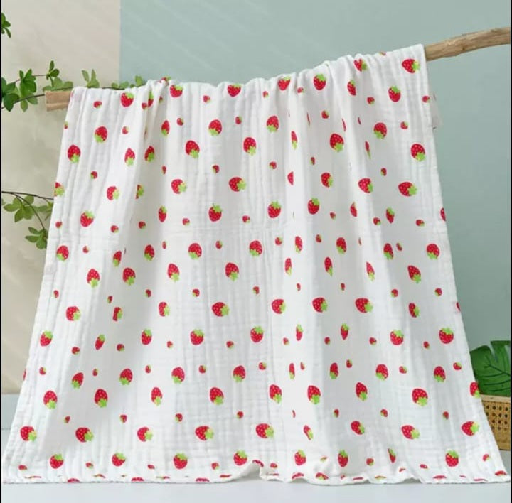 A large muslin baby blanket, made from bamboo and cotton fibres. This blanket is perfect for a baby nursery or out and about in a buggy. The blanket features a cute strawberries pattern.